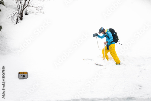 Young caucasian skier walking a snow wall at the Pyrenees.