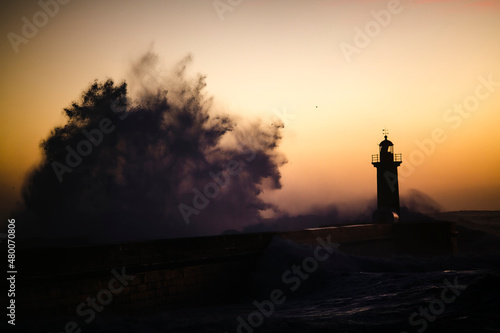 Lighthouse during a storm at Atlantic ocean, Porto, Portugal.