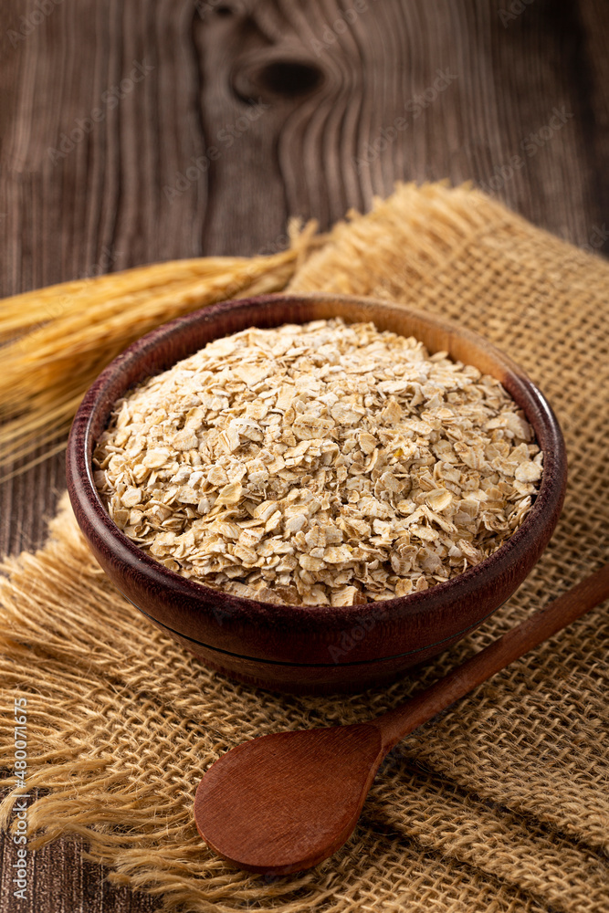 Oat flakes in wooden bowl. Oat flakes in wooden bowl.
