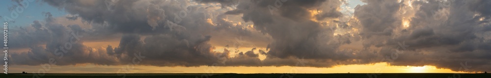 Fototapeta premium Leaden, storm clouds covered the sunset. Cumuliform cloudscape on blue sky. Tragic gloomy sky.