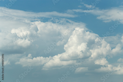 Fototapeta Naklejka Na Ścianę i Meble -  Cumuliform cloudscape on sky. Panorama. The sun is hidden.  Cumulonimbus clouds.