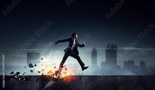 Portrait of energetic businessman running . Mixed media