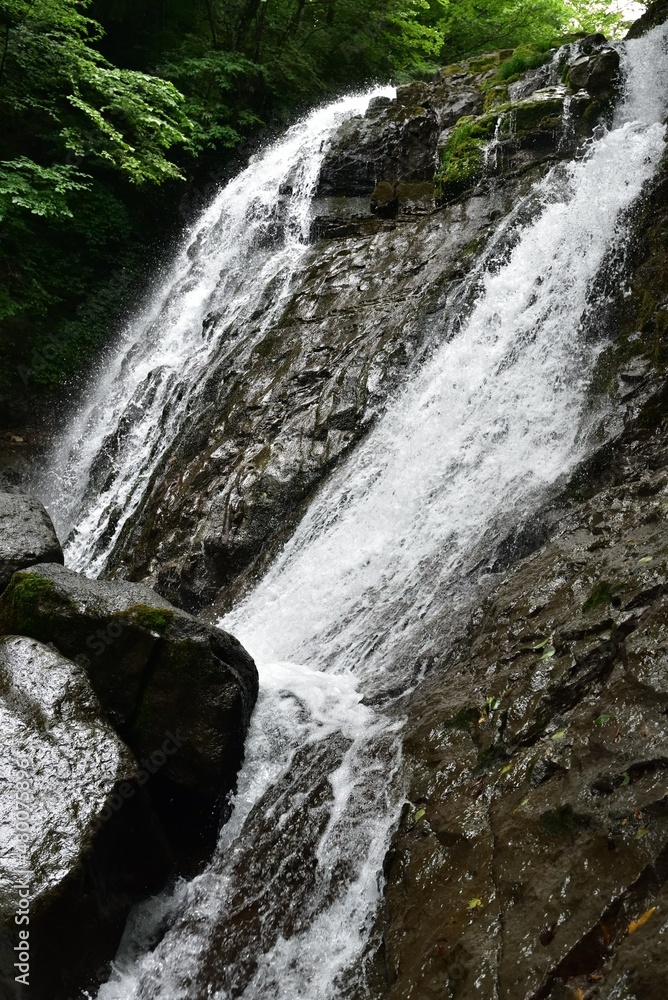 Naklejka premium trekking around waterfall in summer