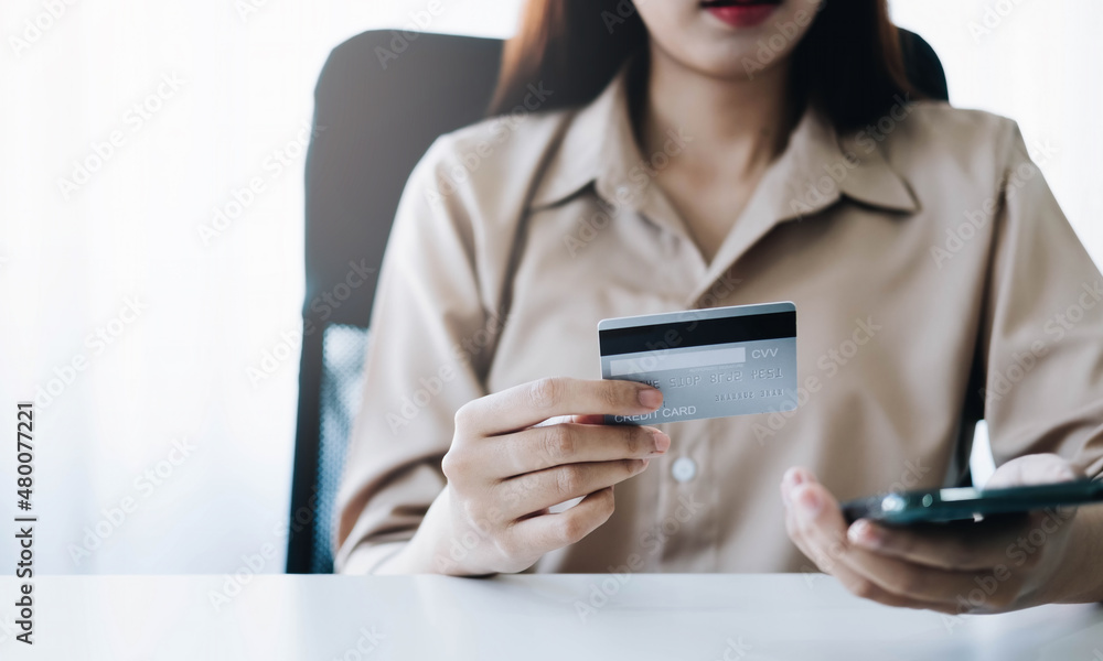 Online payment,woman's hands holding smartphone and using credit card for online shopping. Cyber Monday Concept Online payment,woman's hands holding smartphone and using credit card for online shopping. Cyber Monday Concept
