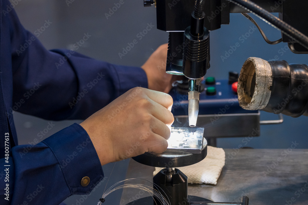 Closeup scene of laser welding operator working with mold parts. Closeup scene of laser welding operator working with mold parts.