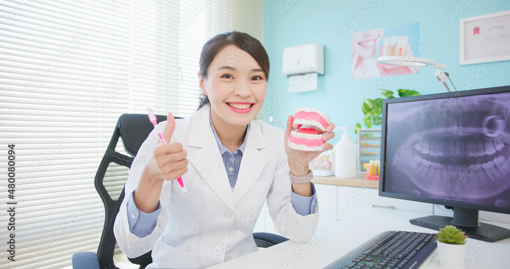 female dentist at dental clinic - obrazy, fototapety, plakaty 