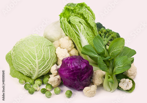 Group of green vegetables and fruits on white background.