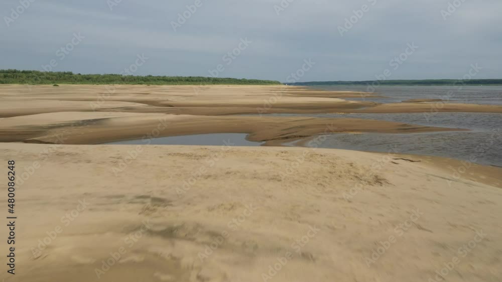 Beautiful sandy river bottom at low tide in northern Siberia on a sunny summer day Beautiful sandy river bottom at low tide in northern Siberia on a sunny summer day