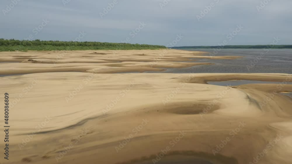 Beautiful sandy river bottom at low tide in northern Siberia on a sunny summer day Beautiful sandy river bottom at low tide in northern Siberia on a sunny summer day