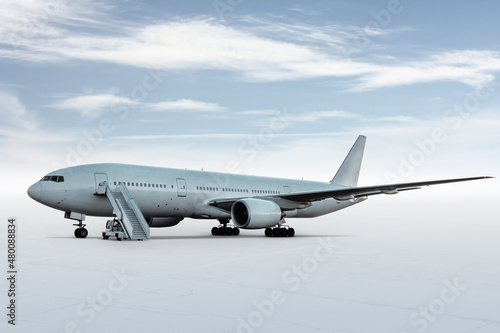 Wide body passenger airplane with a boarding steps isolated on bright background with sky