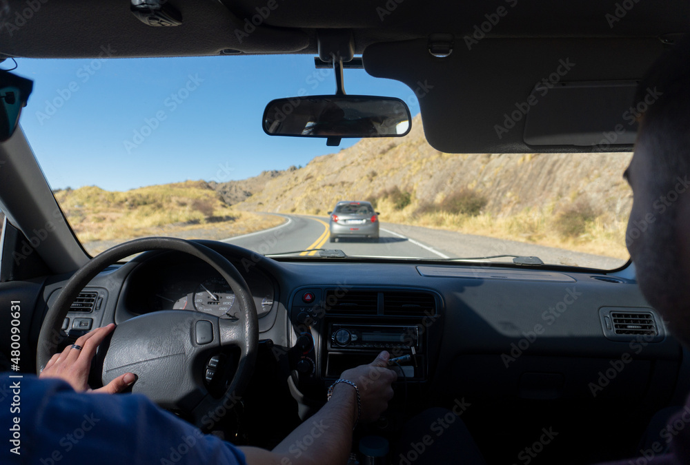 Young male couple driving a car on a trip travel holiday
