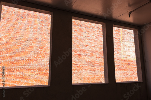 Three Windows Looking Onto Brick Wall