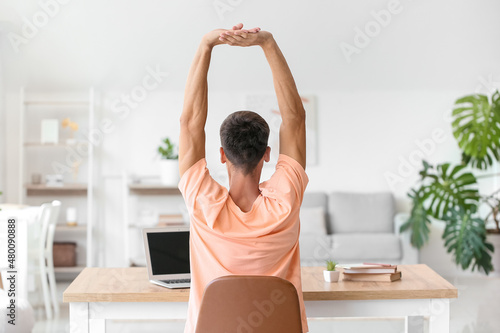 Young man stretching his sp...