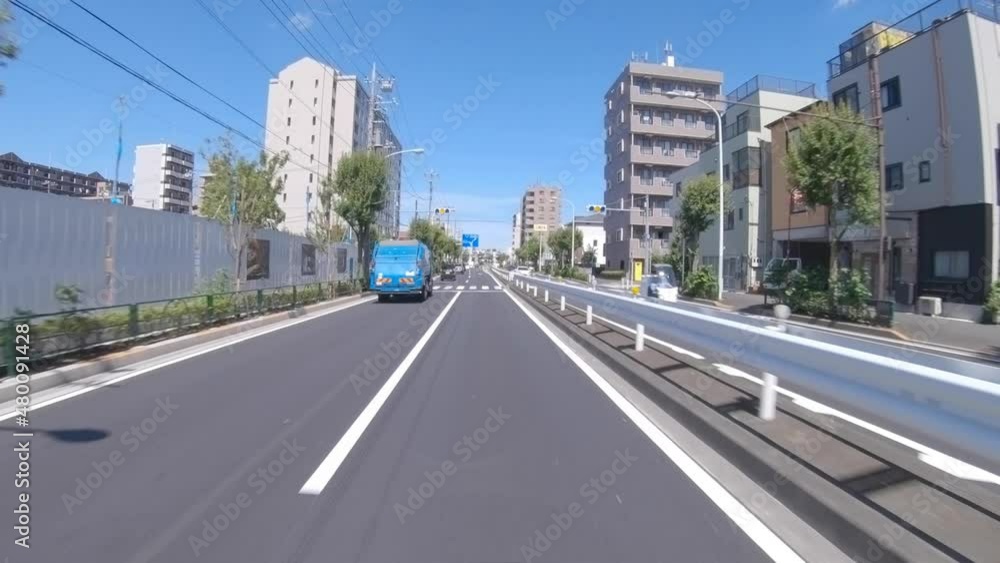 A pov of driving cityscape on the city street in Tokyo in summer wide shot A pov of driving cityscape on the city street in Tokyo in summer wide shot