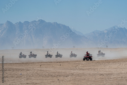 People driving quad bikes during safari trip in Arabian desert not far from Hurghada city, Egypt