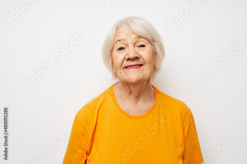 Portrait of an old friendly woman holding a glass of water health close-up emotions