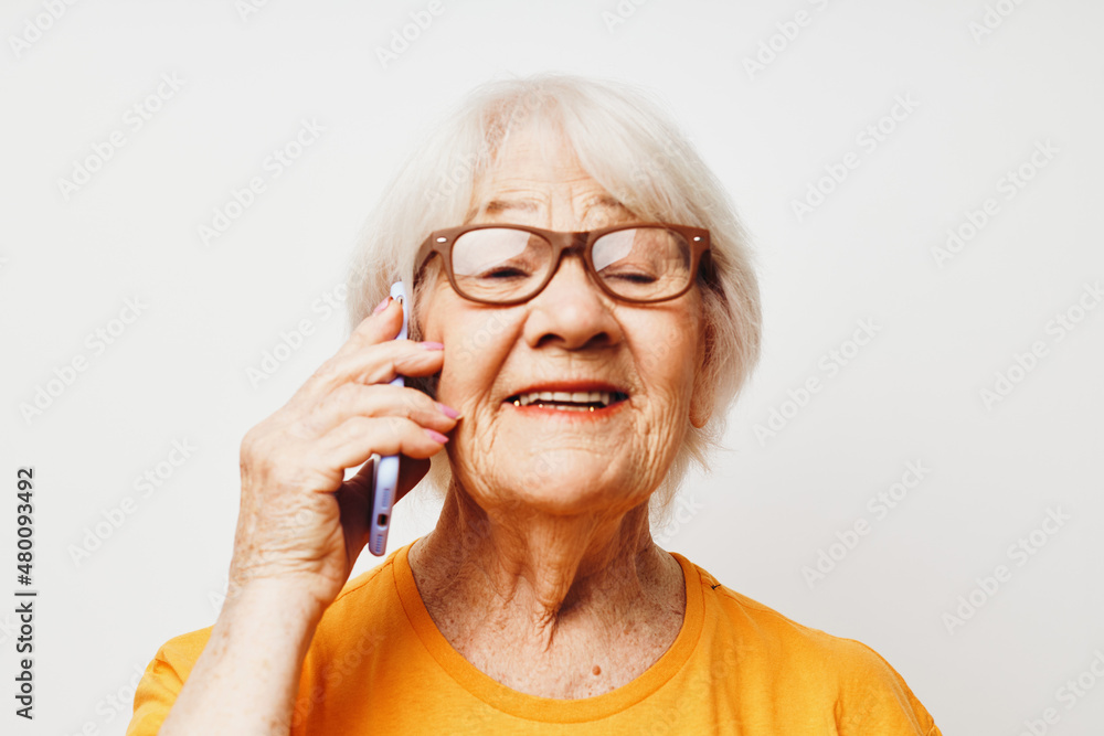 smiling elderly woman in casual t-shirt sunglasses talking on the phone cropped view smiling elderly woman in casual t-shirt sunglasses talking on the phone cropped view