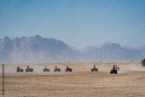People driving quad bikes during safari trip in Arabian desert not far from Hurghada city, Egypt