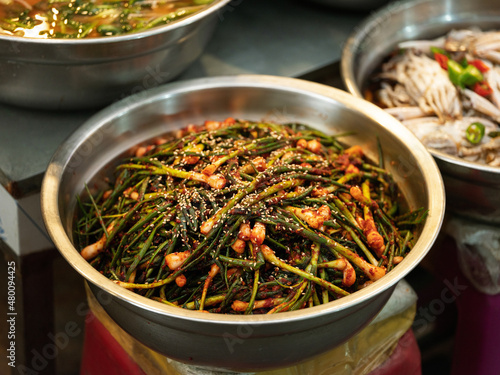 Green onion kimchi displayed in a traditional market