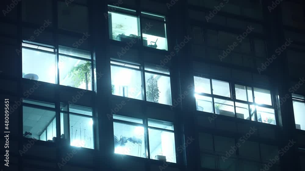 aerial view of modern office buildings with illuminated window at night aerial view of modern office buildings with illuminated window at night