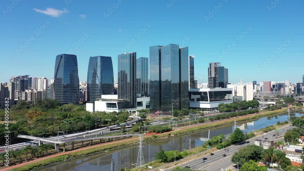 Panoramic landscape of famous buildings and highway roads between scenic river at downtown Sao Paulo Brazil. Urban aerials. Cityscape scenery. Landmark city. Panoramic landscape of famous buildings and highway roads between scenic river at downtown Sao Paulo Brazil. Urban aerials. Cityscape scenery. Landmark city.