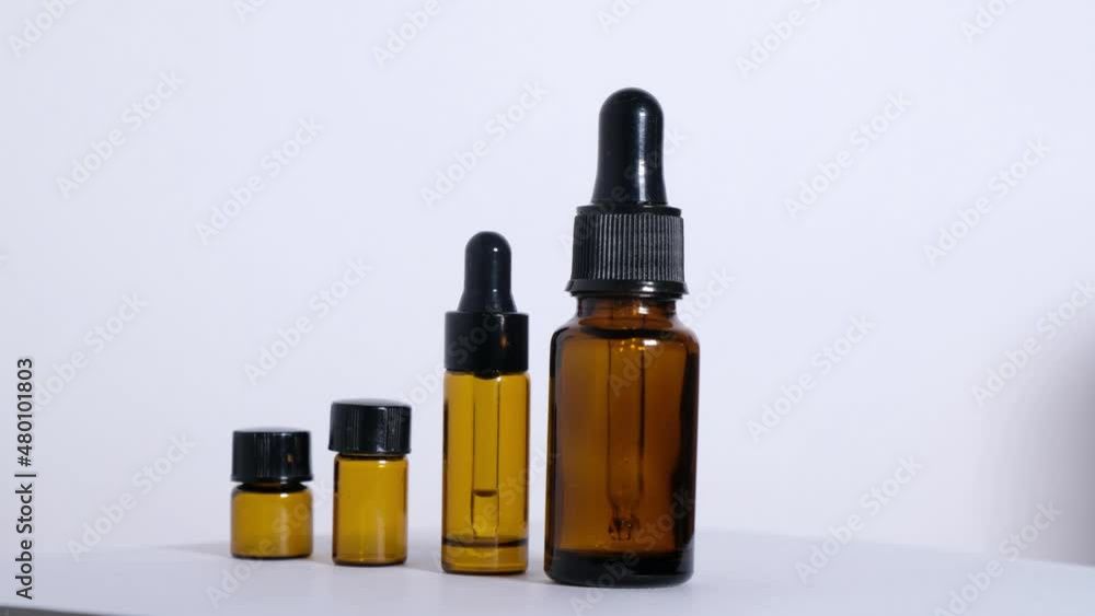 Different empty bottles of essential oils rotate 180 degrees on a white background. High quality 4k footage Different empty bottles of essential oils rotate 180 degrees on a white background. High quality 4k footage