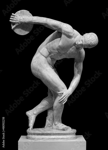 Discus thrower discobolus statue. A part of the ancient Olymp games. A Roman copy of the lost bronze Greek sculpture. Isolated on black background photo