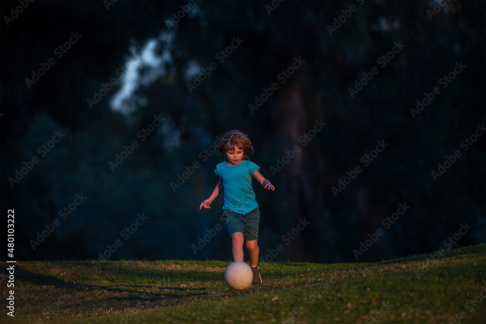 Soccer kid. Kids play football on outdoor stadium field. Little boy kicking ball. School football sports club. Training for sport children. Active ball games. Soccer kid. Kids play football on outdoor stadium field. Little boy kicking ball. School football sports club. Training for sport children. Active ball games.