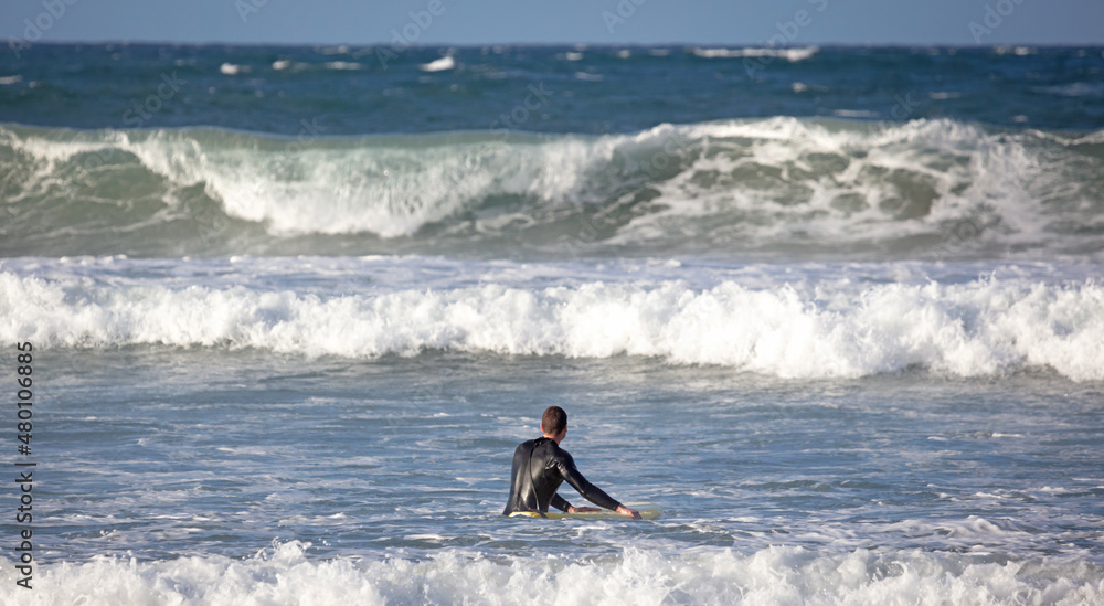 Surfer practicing his skills in the Atlantic ocean at Lanzarote Surfer practicing his skills in the Atlantic ocean at Lanzarote