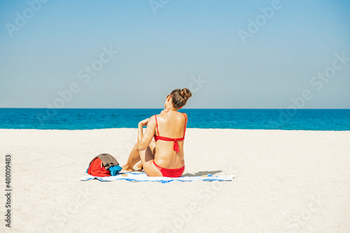 Skin care. Sun protection. Woman apply sun cream. Woman With Suntan Lotion On Beach. Suncream. Girl Holding Moisturizing Sunblock.