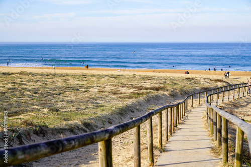 access ocean sandy pathway fence wooden to ocean beach atlantic sea coast at talmont saint hilaire vendee France photo