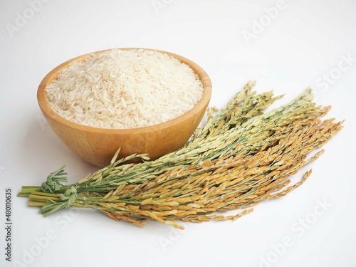Rice in wooden bowl isolated on white background. closeup photo, blurred.