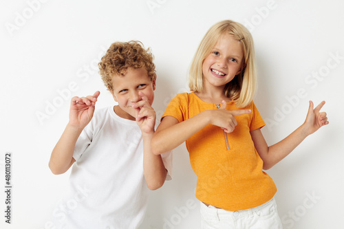picture of positive boy and girl casual clothes posing emotions studio isolated background unaltered