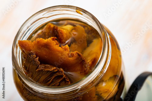 Close-up of tasty canned milk mushrooms marinated at glass jar