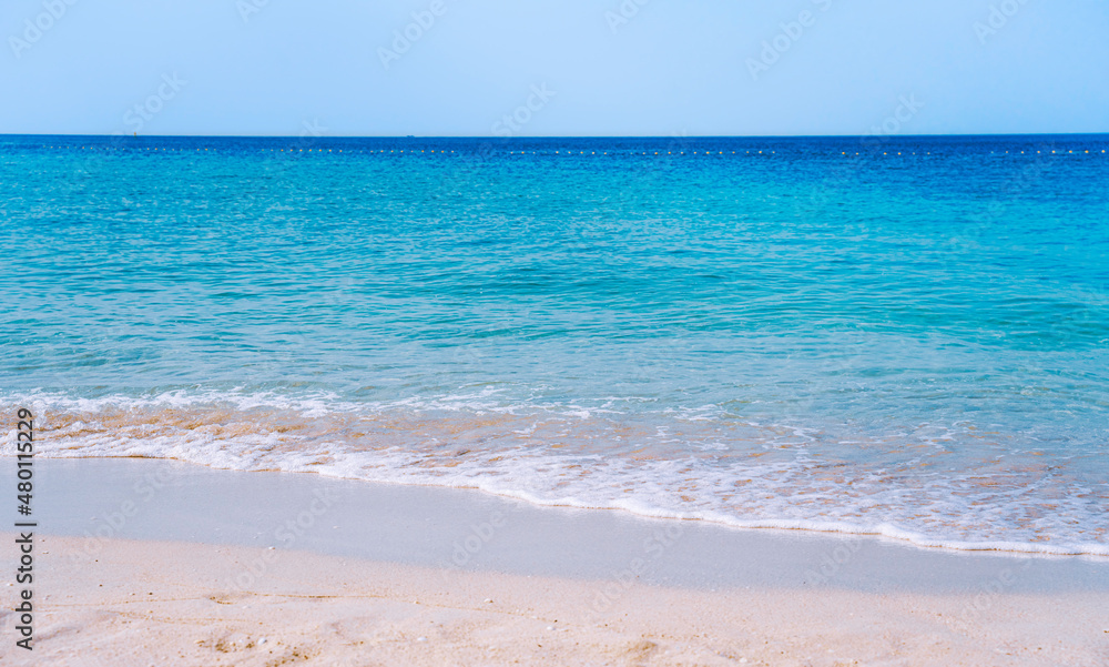 A beautiful beach with white sand and turquoise waters.