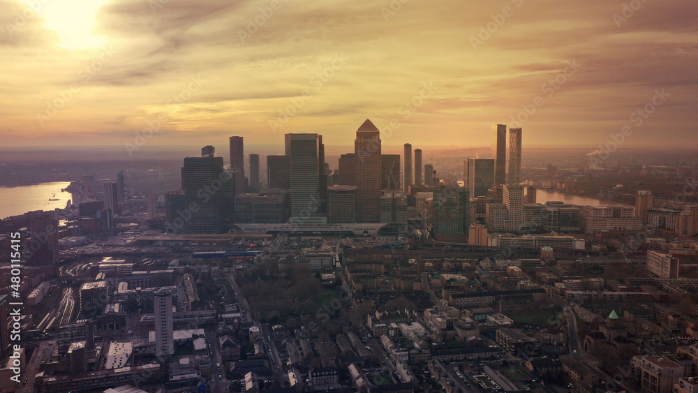 Aerial drone photo of iconic skyscraper banking and business complex of Canary Wharf at sunset, Docklands, London, United Kingdom