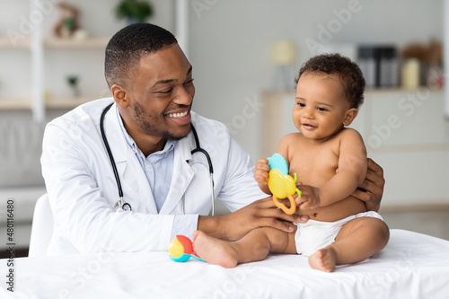 Portrait Of Black Doctor Making Medical Check Up For Little Baby Patient photo