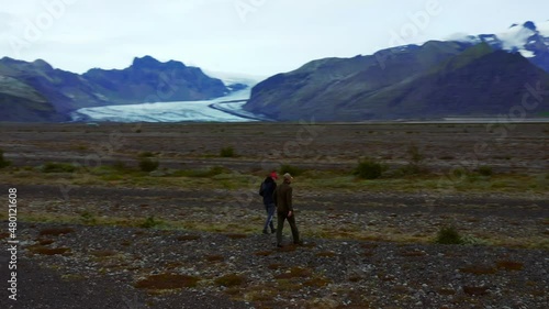 Two Men Walking And Exploring At Skeidararsandur Plain Near Famous Svinafellsjokull And Skaftafell Glaciers In Iceland. - aerial photo