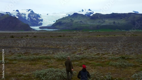 Men Running On The Field At Skeidararsandur With Svinafellsjokull Glacier In The Distance. - aerial photo