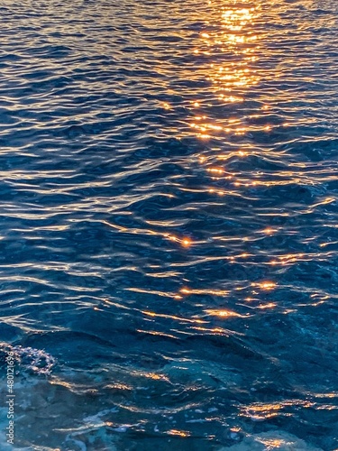 Sparkles of the sunshine on the sea water surface, natural colors