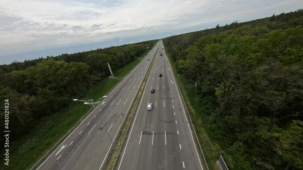 FPV flight along a nearly empty highway passing through the forest FPV flight along a nearly empty highway passing through the forest