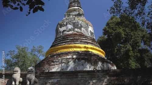 A tilt establishing shot of the spectacular Wat Mae Nang Pleum Pagoda, one of the many beautiful temples in the Ayutthaya Kingdom in Thailand photo