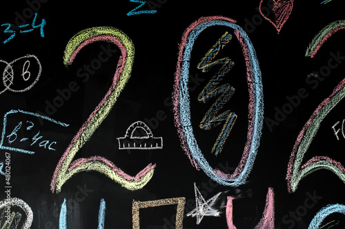 school board with numbers and drawings drawn in chalk
