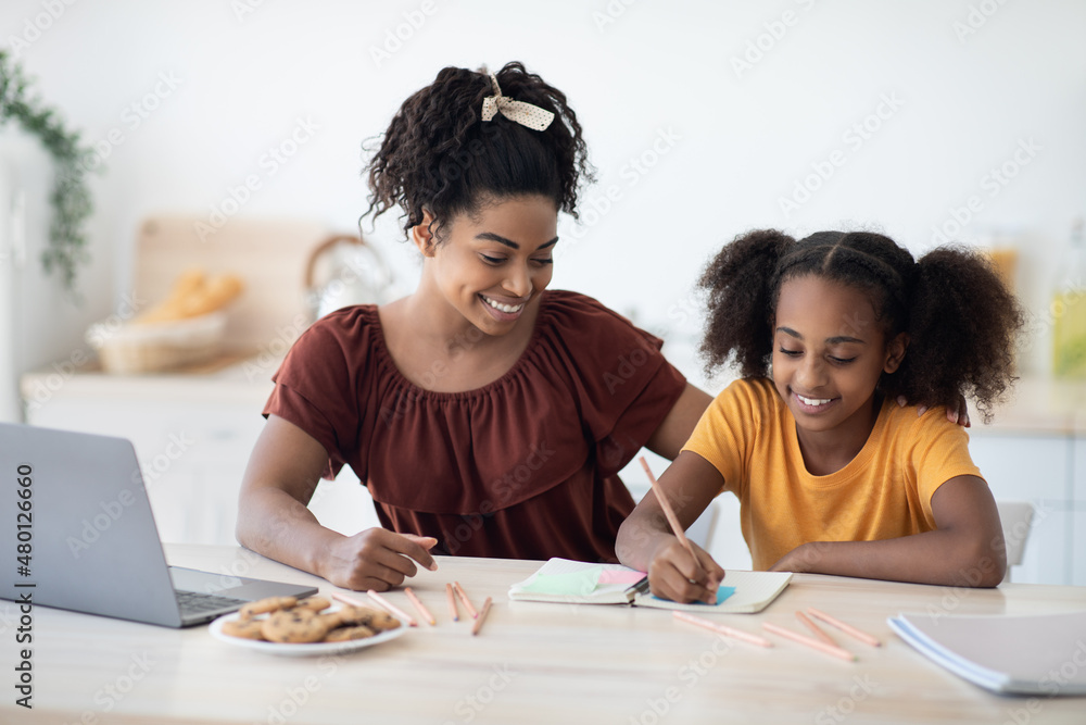 Loving black mother and daughter drawing together at home Loving black mother and daughter drawing together at home