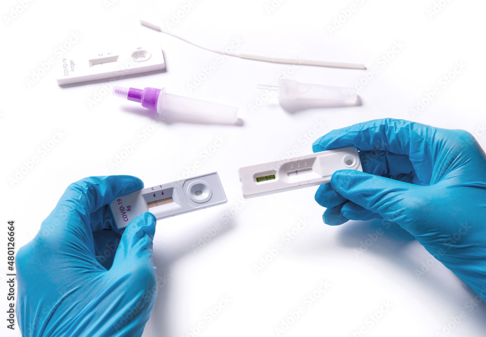 Doctor holding a COVID-19 test kit Test results are negative, not infected with coronavirus. with an antigen test kit (ATK) Doctor holding a COVID-19 test kit Test results are negative, not infected with coronavirus. with an antigen test kit (ATK)