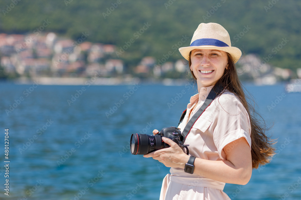 Young woman taking photo with camera on her vacation trip in Europe.