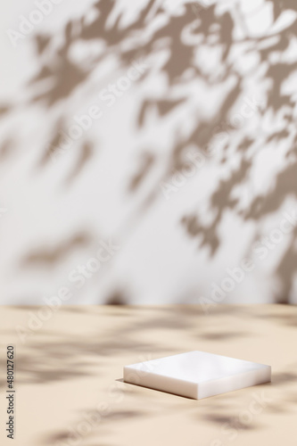 Abstract minimal nature scene - empty stage and square podium on beige background and soft shadows of tree leaves. Pedestal for cosmetic product and packaging mockups display presentation