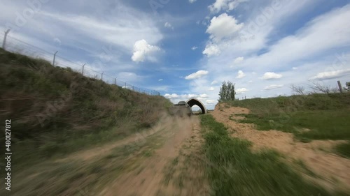 FPV flight pursuit of a military armoured personnel carrier at training photo