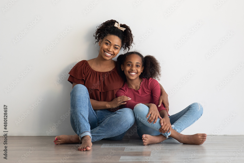 Loving black family posing on floor at home Loving black family posing on floor at home