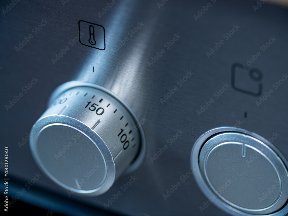 Kitchen oven, closeup rotary switch to adjust temperature. Stove in